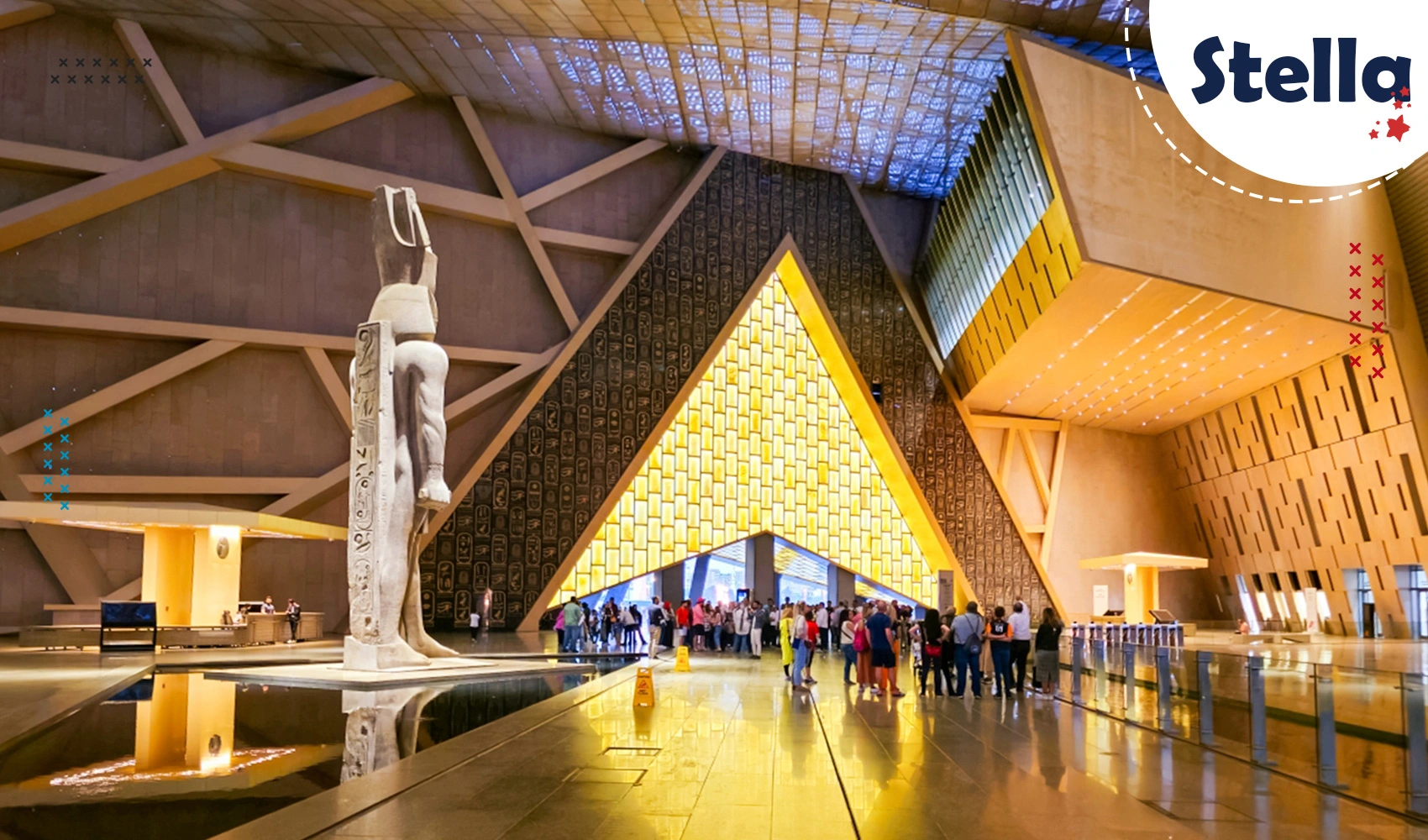 The stone and glass entrance of the Grand Egyptian Museum near Giza