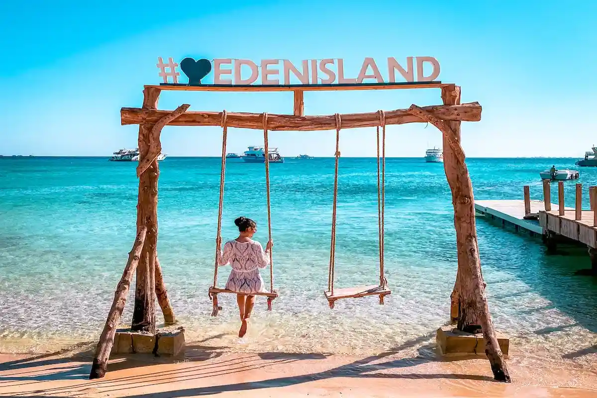 Golden sand, hammocks and calm shallow water on Eden Island