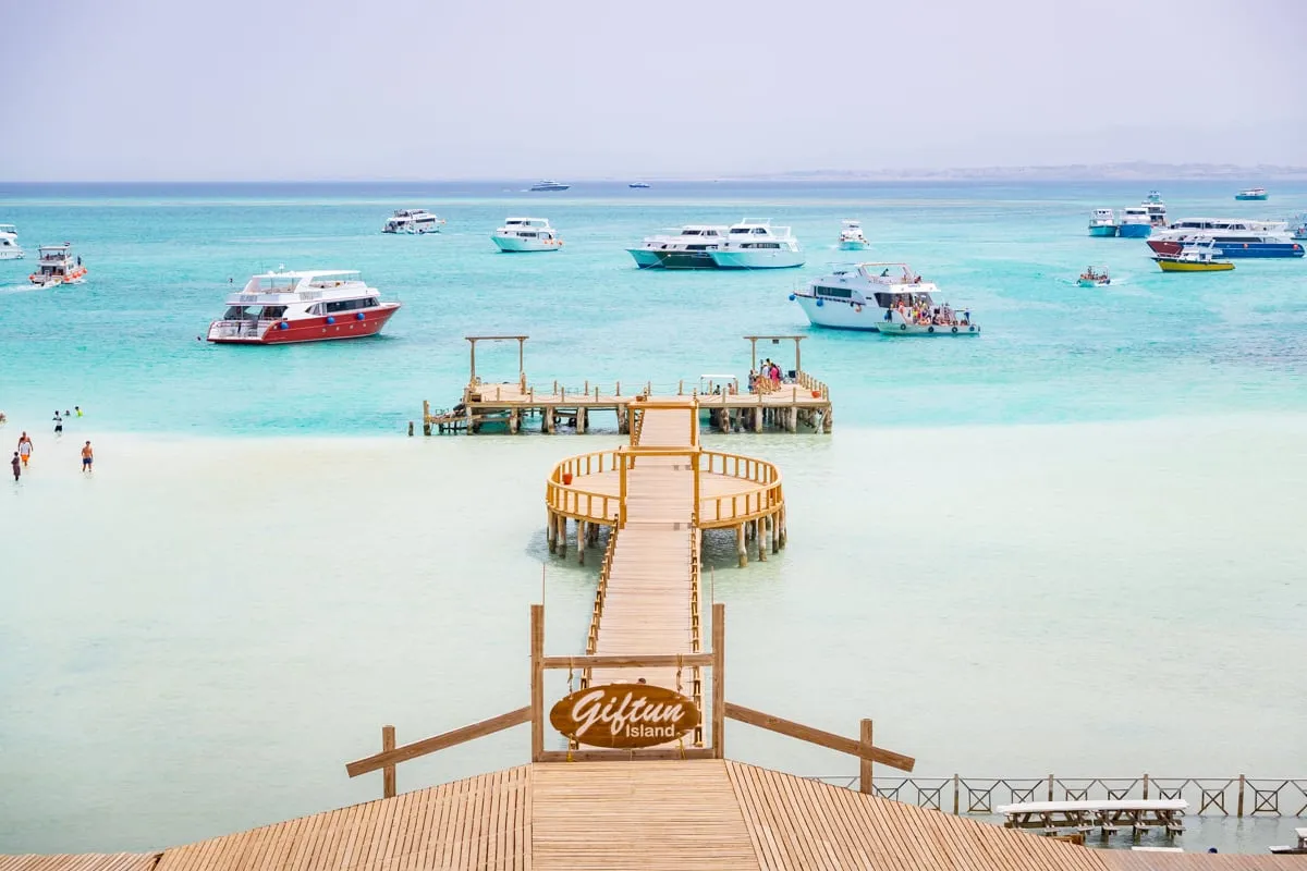 A wooden jetty leading out over clear water at Orange Bay